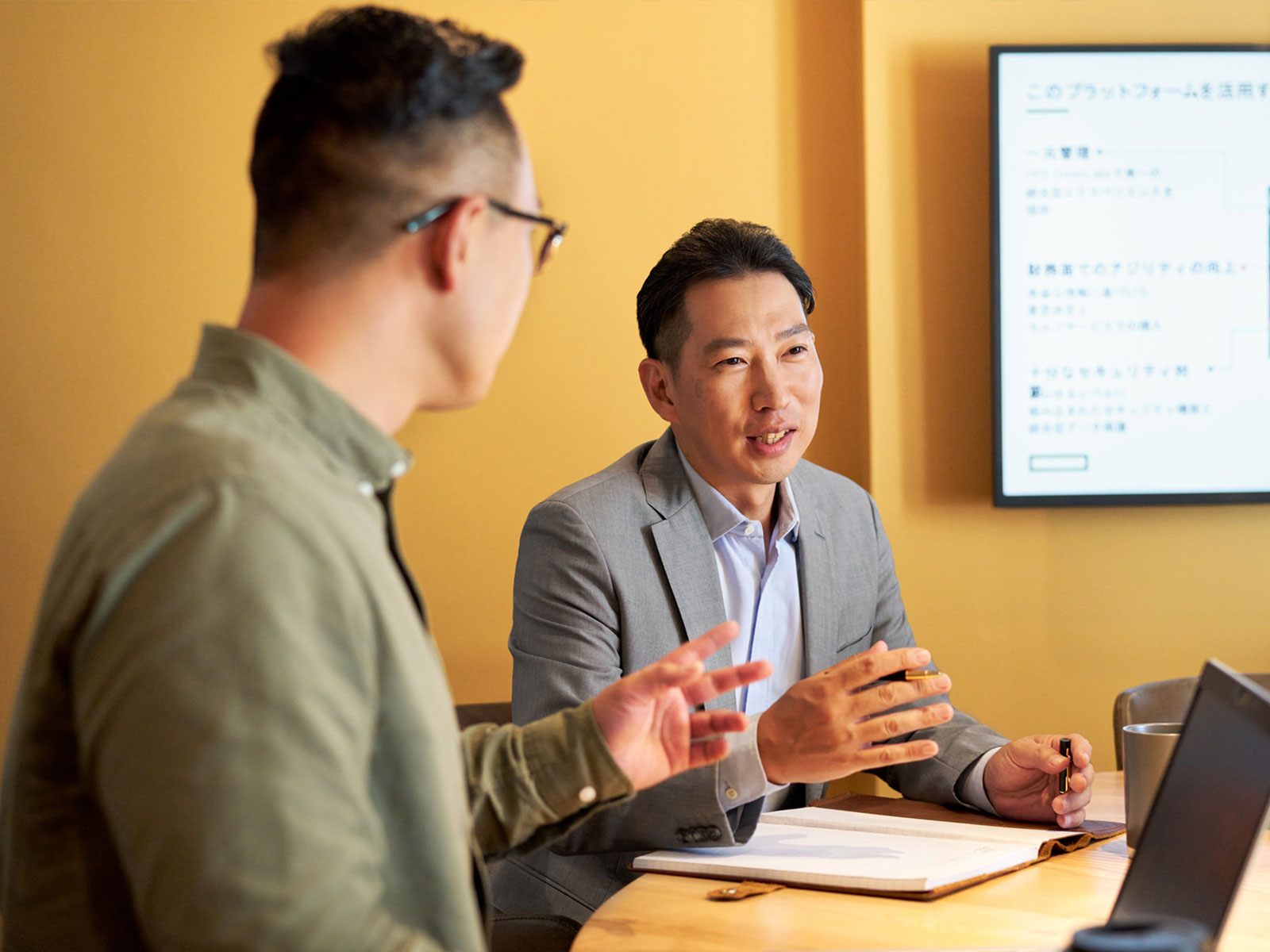 Two employees in a meeting room.