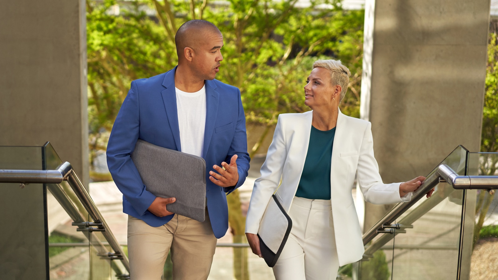 Two business people walking and talking.