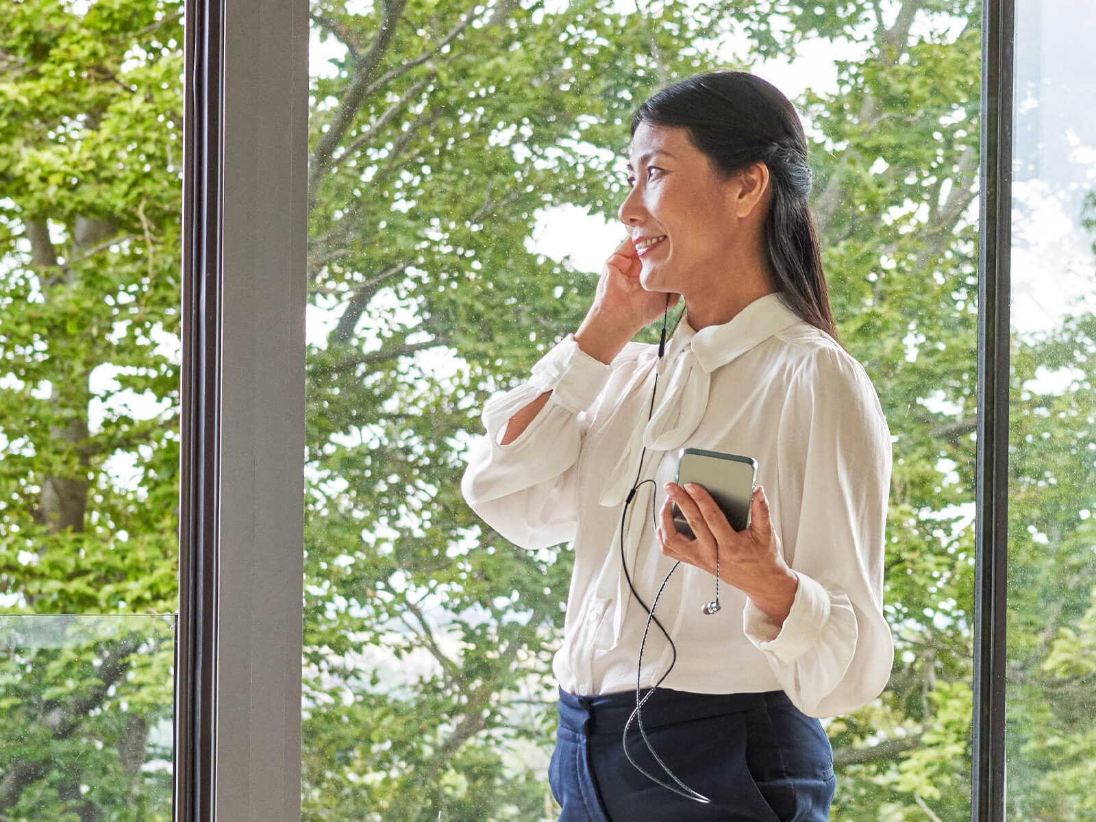 Portrait of business person, talking through a headphones.