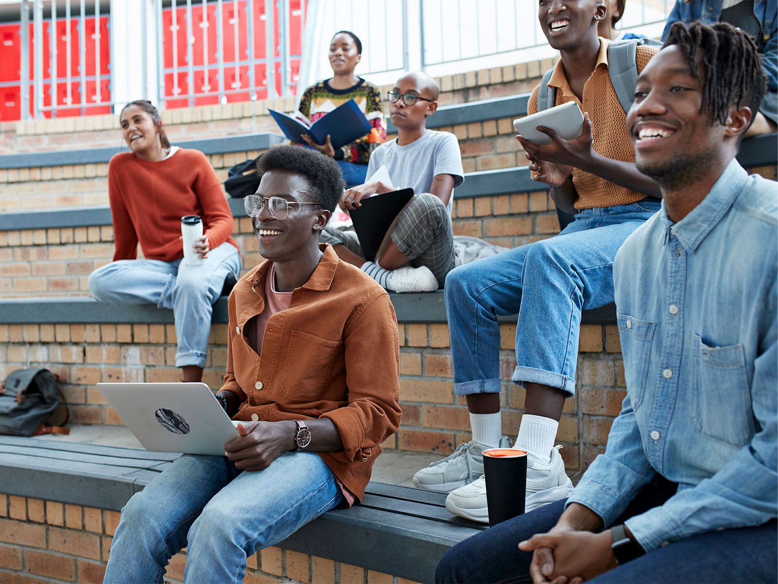 Students smiling while taking a class outside