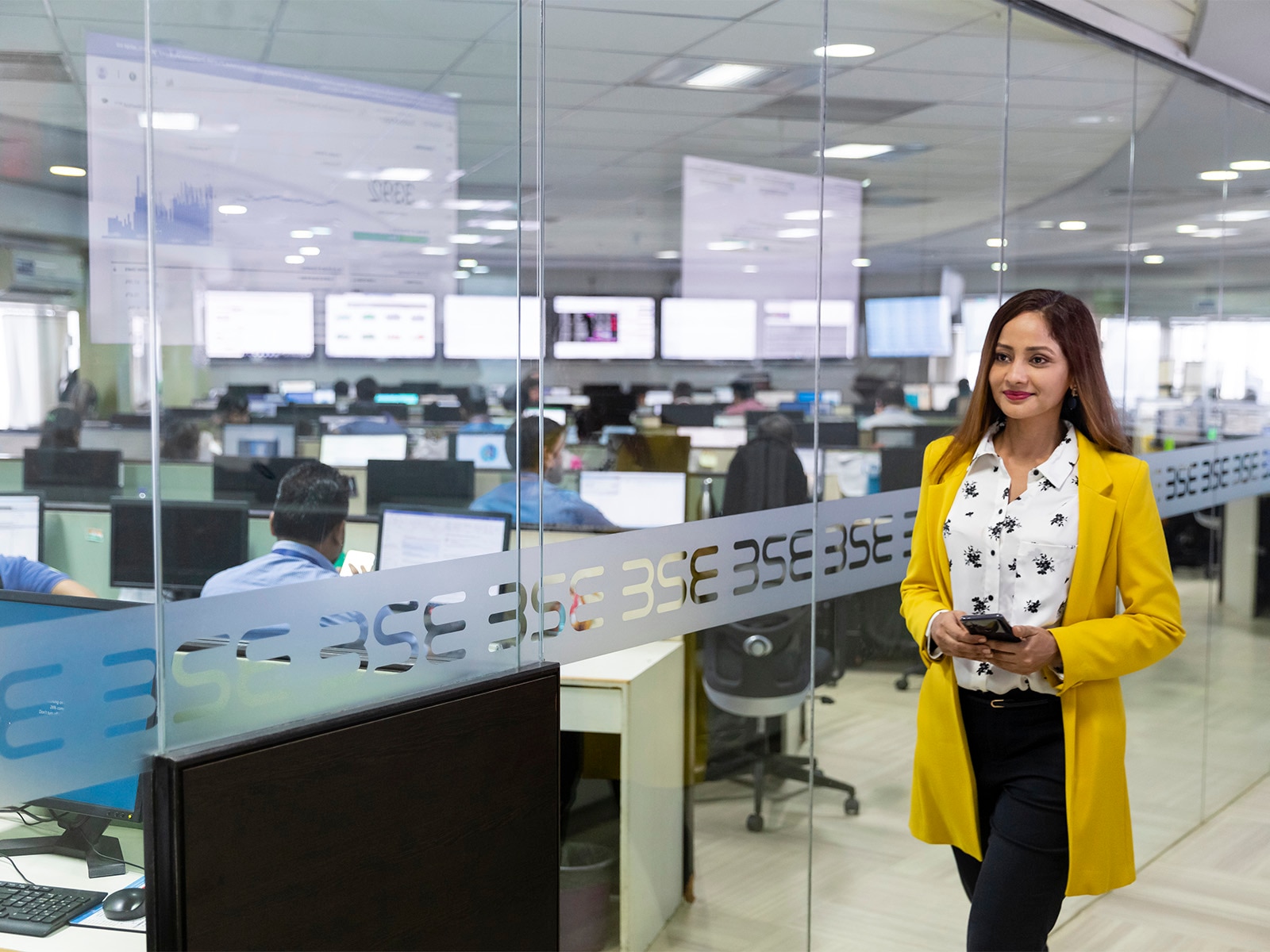 Woman walking through the Stock Exchange office.