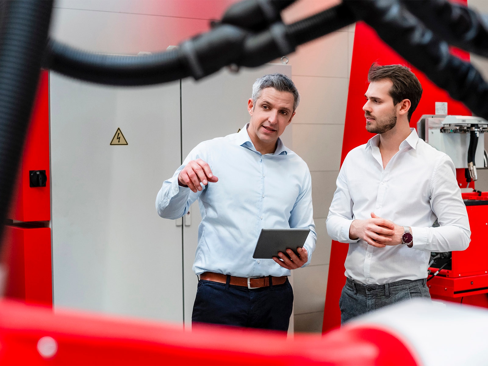 Engineers with a tablet discussing digital transformation plan.