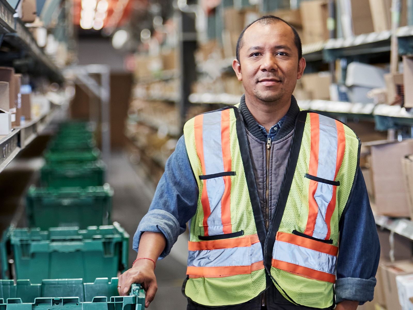 Man surrounded by boxes – learn how storage management enable organizations to deliver fast access to data.